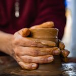 Artisan shaping clay pot on a pottery wheel in İznik, Türkiye.